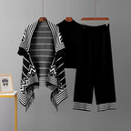 Black 3-piece knit co-ord set laid flat showing fringe cardigan, top, and pants
