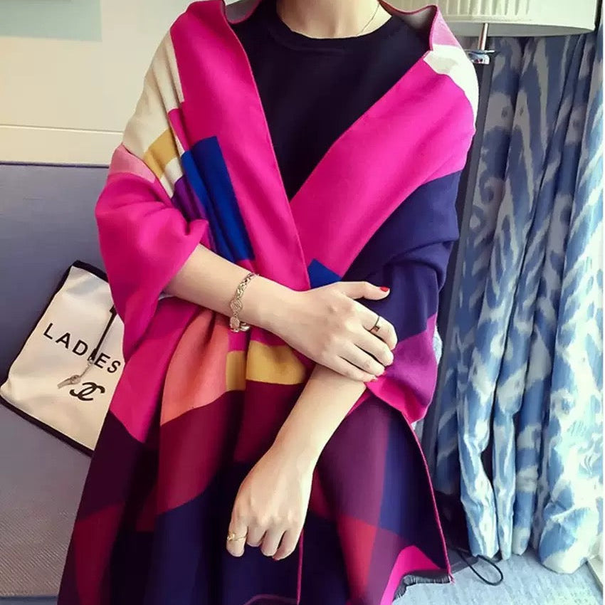 The Fuchsia Mosaic Cashmere Wrap worn as a shoulder wrap showing bold fuchsia mosaic geometric print on soft faux cashmere base
