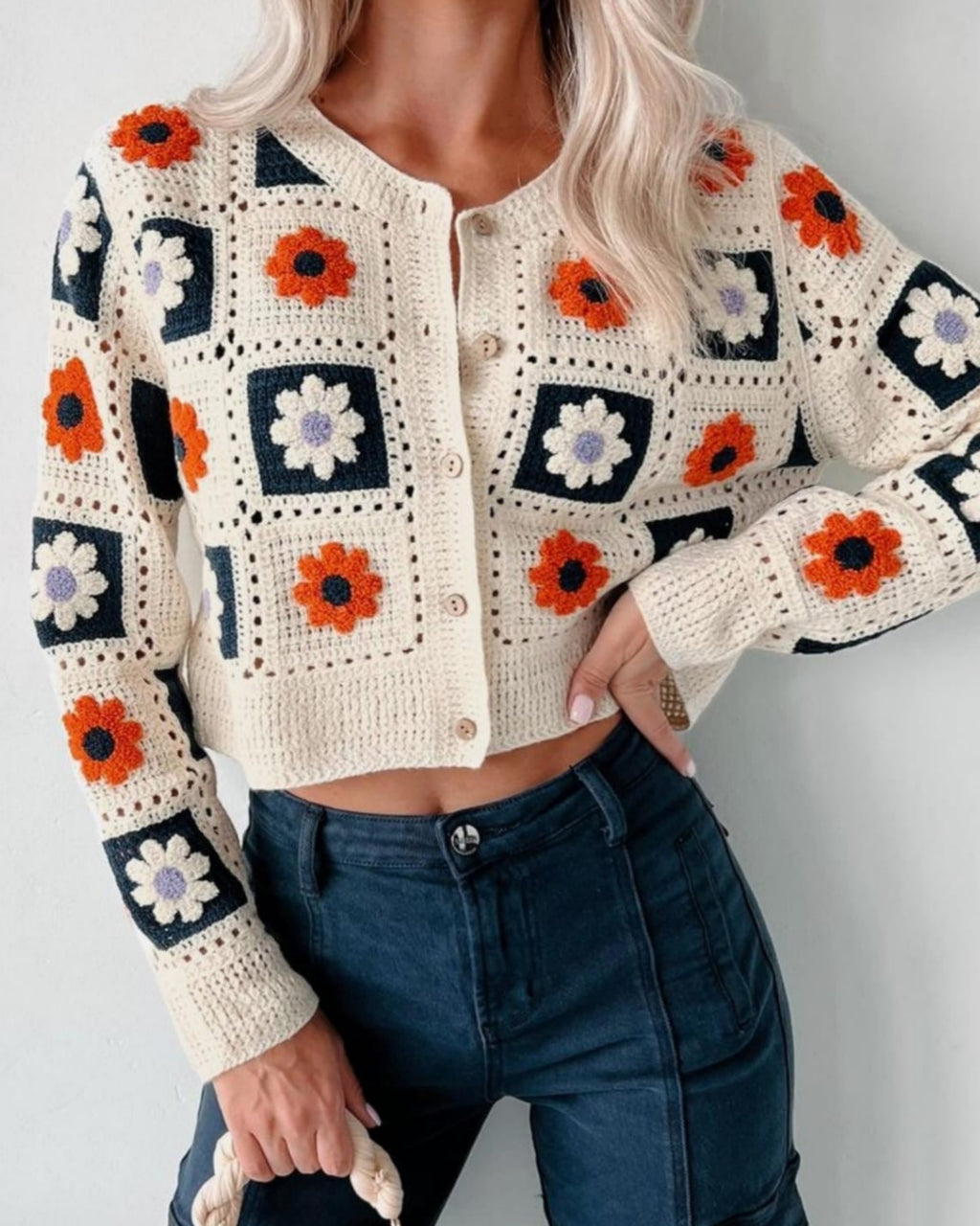 Close-up of Garden Squares Crochet Cardigan in beige showing granny-square floral motifs and button closure