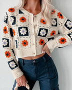 Close-up of Garden Squares Crochet Cardigan in beige showing granny-square floral motifs and button closure