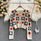 Garden Squares Crochet Cardigan in beige displayed on hanger showing full floral patchwork crochet design