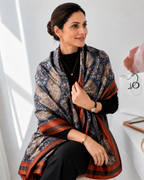 Woman wearing Gia Luxurious Paisley Print Silk Scarf in navy blue and rust with an elegant front drape styling.
