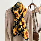 Giza Sunflower Print Viscose Cotton Scarf in alternate view showing sunflower bloom detail and smooth viscose cotton fabric texture on black ground

