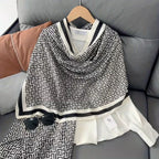 Woman styling black white Greek key stole over white shirt - professional office look