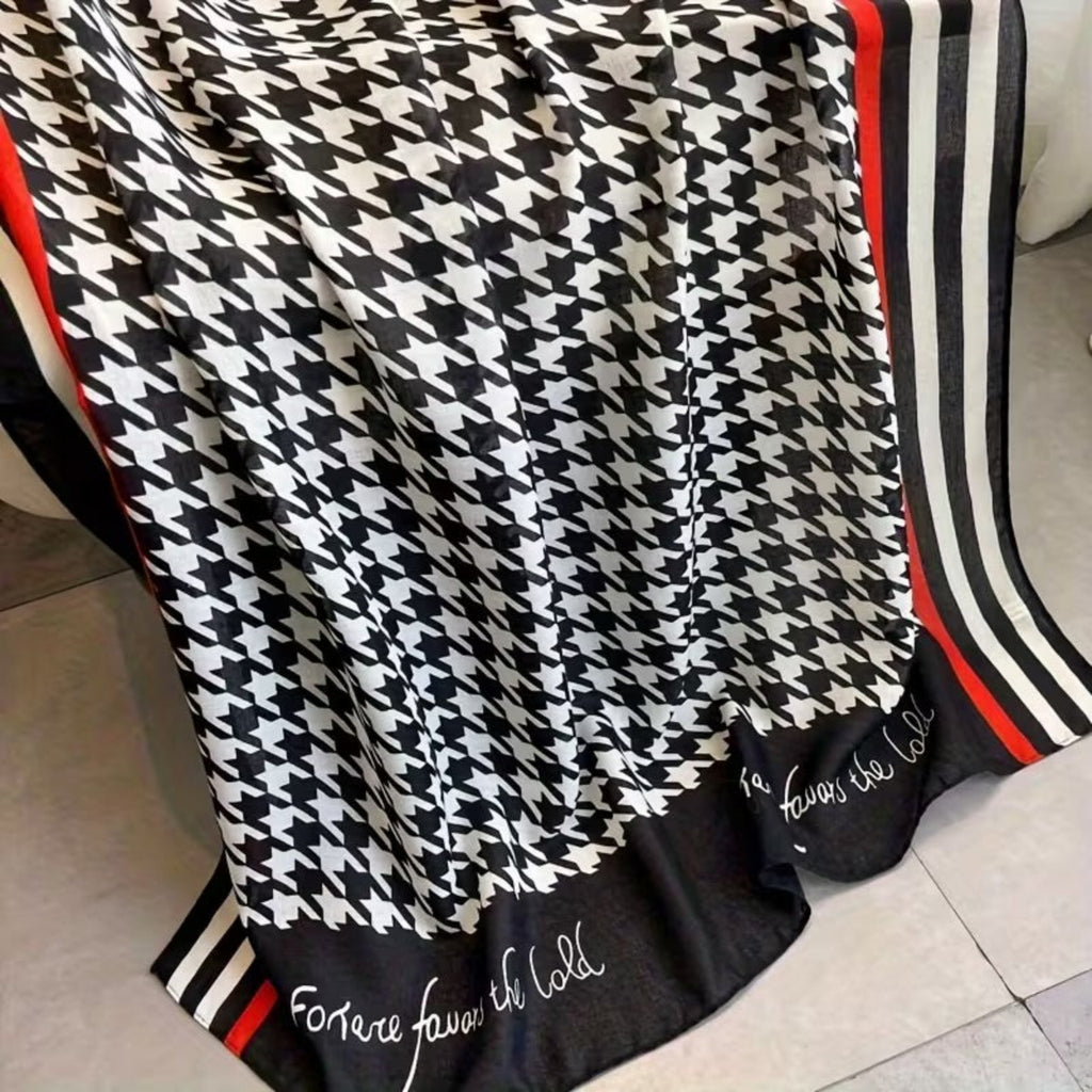 Close-up of houndstooth stole showing red stripe border and elegant text detail - viscose cotton fabric