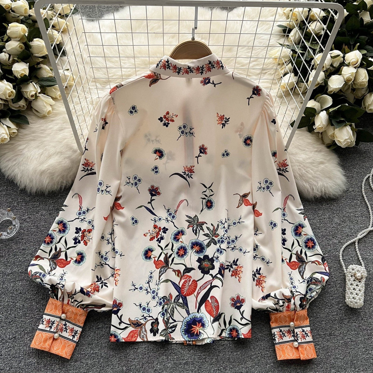 Back view of Jardin Bloom Satin Shirt on hanger showing botanical ombré floral print across back and balloon sleeves
