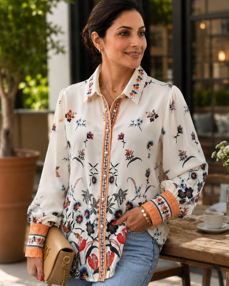 Woman wearing Jardin Bloom Satin Shirt styled with blue denim jeans and tan handbag showing full front floral print

