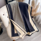 The Kensington Houndstooth Wrap laid flat displaying full classic houndstooth two-tone check pattern on faux cashmere fabric
