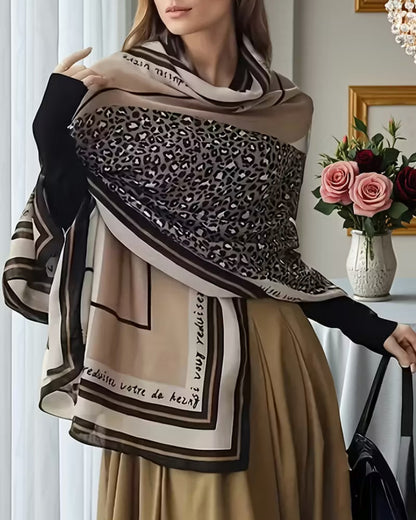 Woman wearing leopard print viscose cotton stole with striped border - beige black scarf