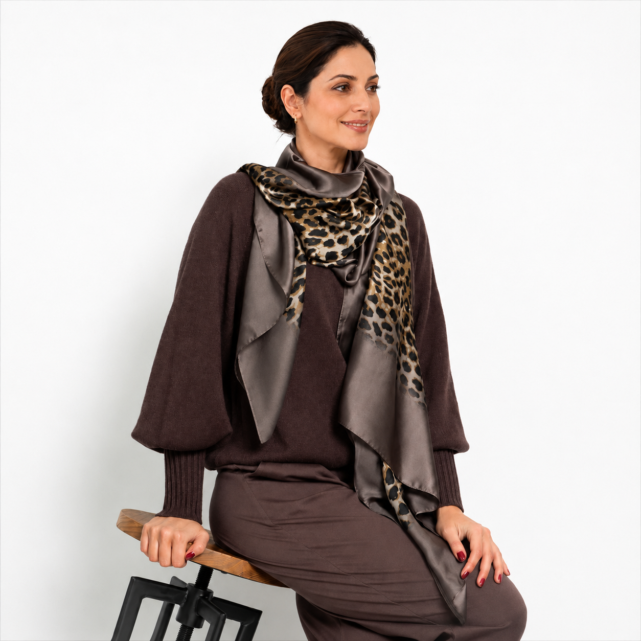 Woman wearing the Westery Leopard Whisper Stole in brown satin with elegant leopard print styling.