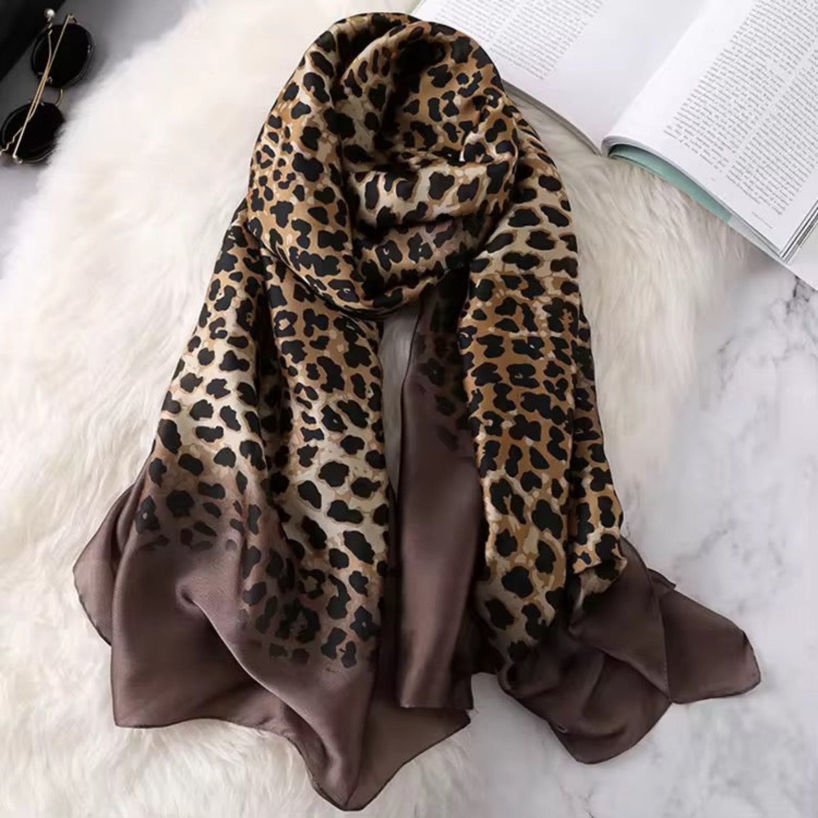 Leopard Whisper Stole in brown satin displayed flat, showcasing the soft sheen and leopard print design.