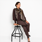 Leopard Whisper Stole styled with a brown knit outfit for an elegant everyday look.