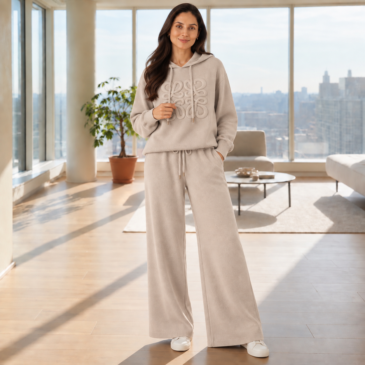 Woman wearing a beige embossed knit hoodie co-ord set with wide-leg pants
