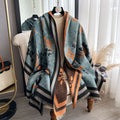 Luxury Reversible Oversized Floral Shawl Wrap draped as a cape on mannequin showing teal blue side with black and orange floral jacquard print and striped border
