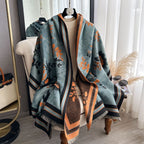 Luxury Reversible Oversized Floral Shawl Wrap draped as a cape on mannequin showing teal blue side with black and orange floral jacquard print and striped border
