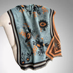 Luxury Reversible Oversized Floral Shawl Wrap laid flat showing full teal blue floral jacquard pattern with black and orange striped border and fringe hem
