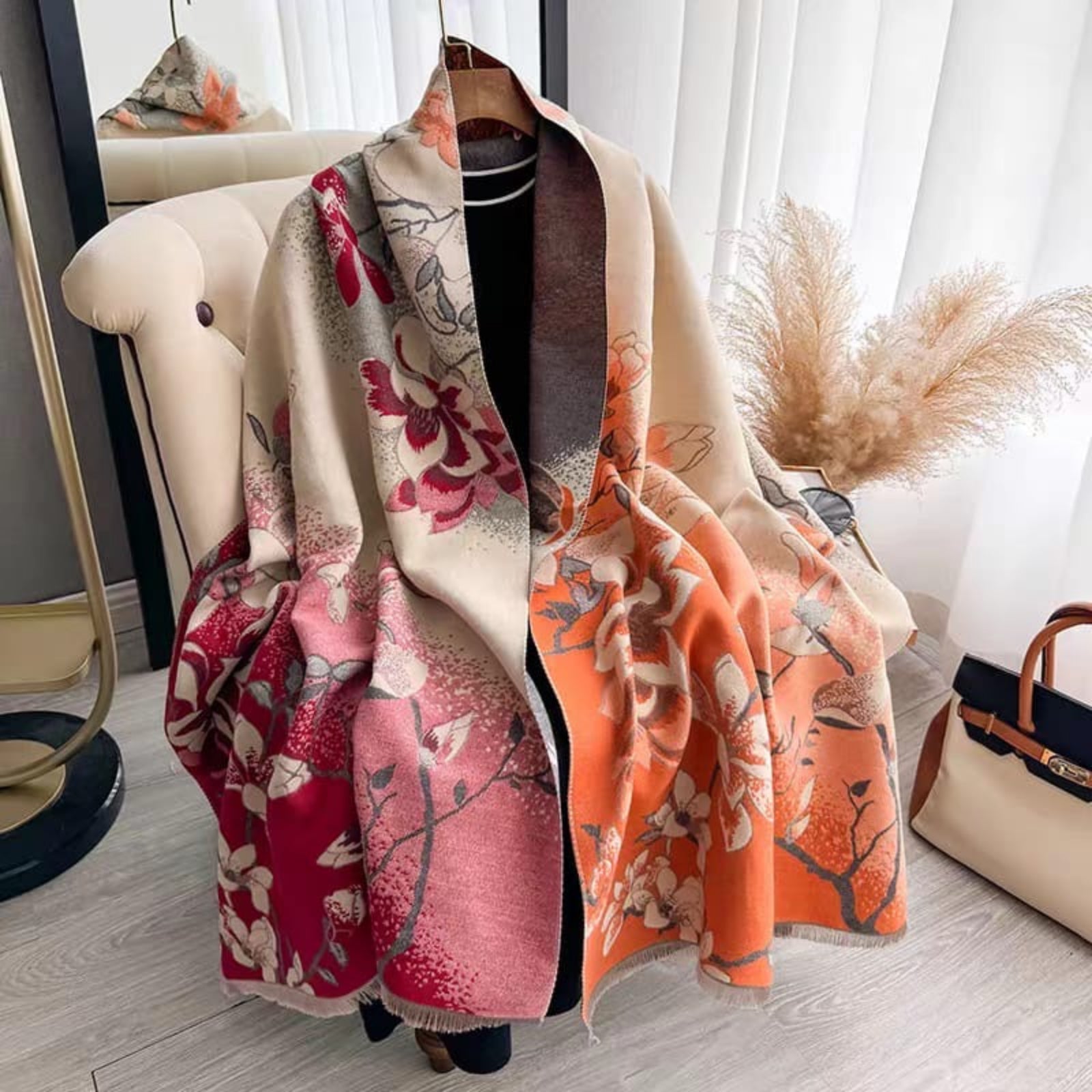 Magnolia Dusk Cashmere Stole draped open showing both reversible sides — sunset orange and crimson rose magnolia floral print