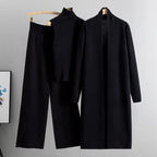 Black 3-piece knit co-ord set laid flat showing top, pants, and cardigan
