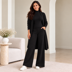 Woman wearing black 3-piece knit co-ord set with longline cardigan and wide-leg pants