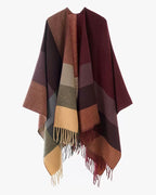 The Merlot Mosaic Cashmere Cape draped over shoulders in cape style showing deep merlot mosaic geometric print and full-coverage silhouette
