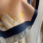 Close-up of Midnight Amber Black Shawl showing soft faux cashmere fabric texture with amber and gold leaf botanical print detail on black ground
