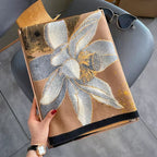 Midnight Amber Black Shawl wrapped around neck showing black and amber gold botanical print and soft faux cashmere drape
