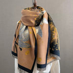 Midnight Amber Black Shawl worn as a shoulder wrap showing black faux cashmere with amber gold botanical leaf print detail
