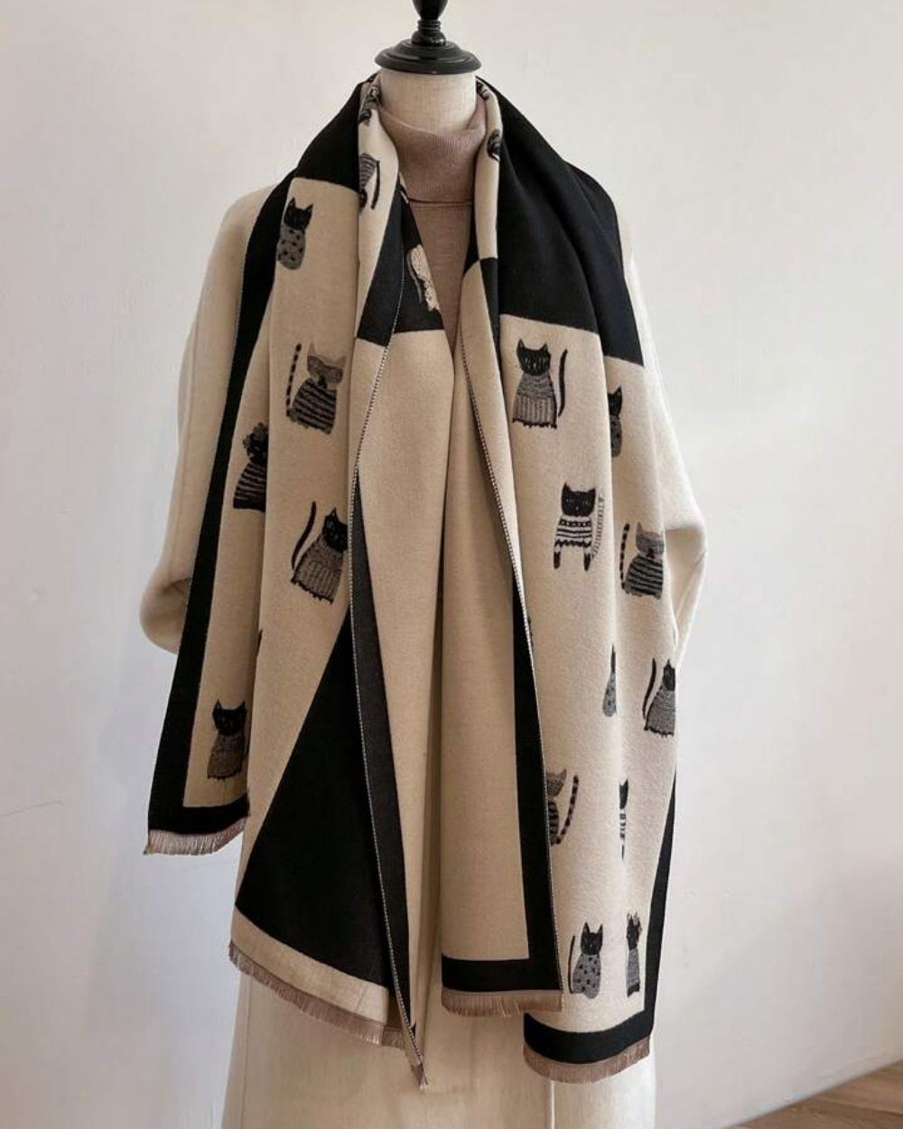 The Midnight Cats Reversible Wrap showing primary midnight side with whimsical illustrated cat motif on soft faux cashmere fabric

