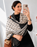 Woman wearing Midnight Polka Luxe Silk Stole draped over shoulders showing black and ivory polka dot print with circular border detail
