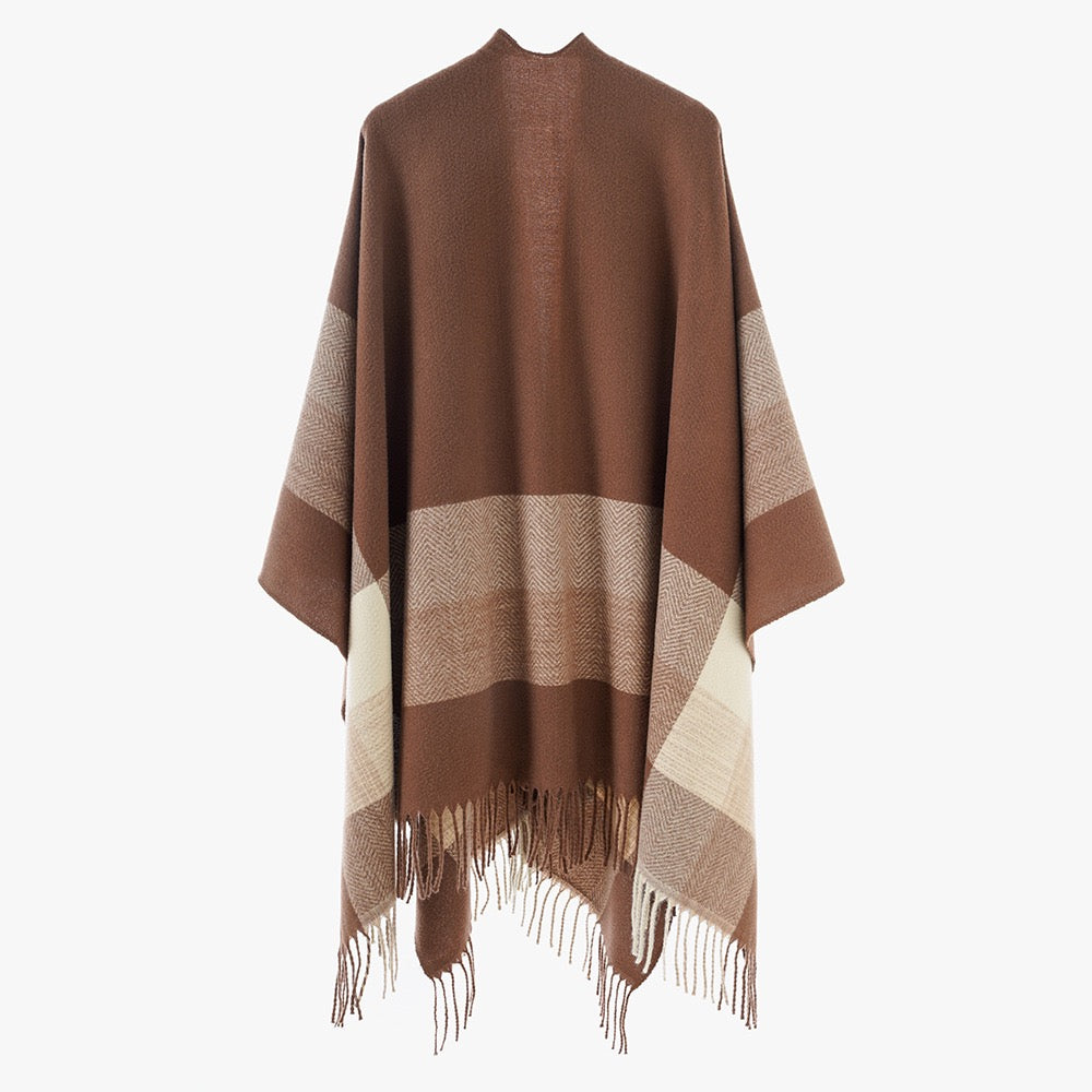 Close-up of The Mocha Herringbone Cashmere Cape showing soft faux cashmere fabric texture with classic herringbone V-weave pattern in warm mocha and cream tones
