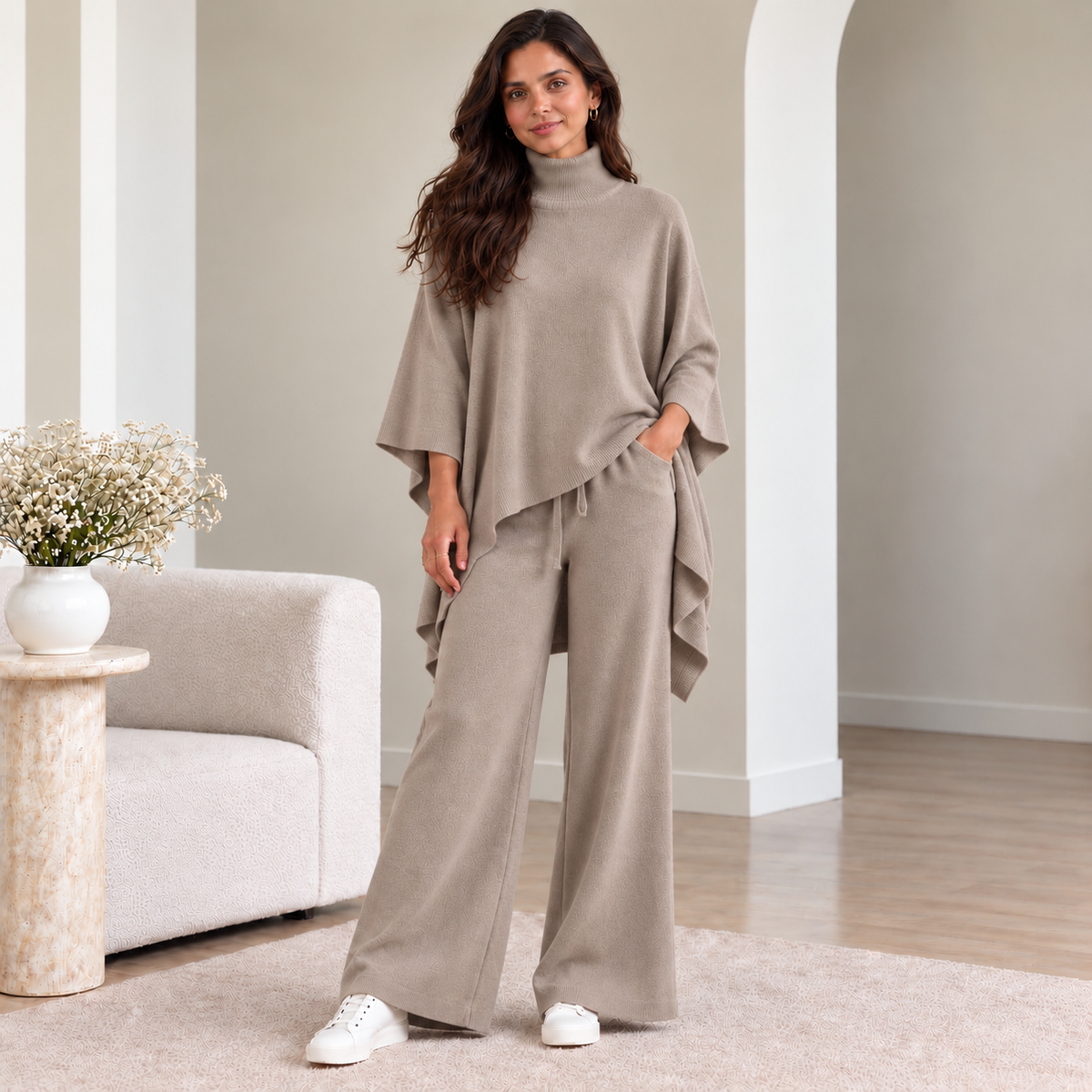 Woman wearing taupe turtleneck poncho knit co-ord set with wide-leg pants
