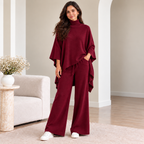 Woman wearing wine turtleneck poncho knit co-ord set with wide-leg pants
