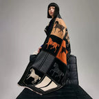 The Noir Equestrian Cashmere Wrap draped and styled showing equestrian heritage print on noir faux cashmere base


