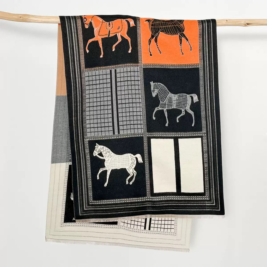 Close-up of The Noir Equestrian Cashmere Wrap showing soft faux cashmere fabric texture with detailed heritage equestrian horse and rider print on noir black base

