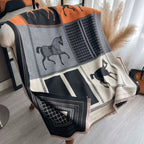 The Noir Equestrian Cashmere Wrap laid flat displaying full heritage equestrian print in contrasting tones on noir black faux cashmere fabric
