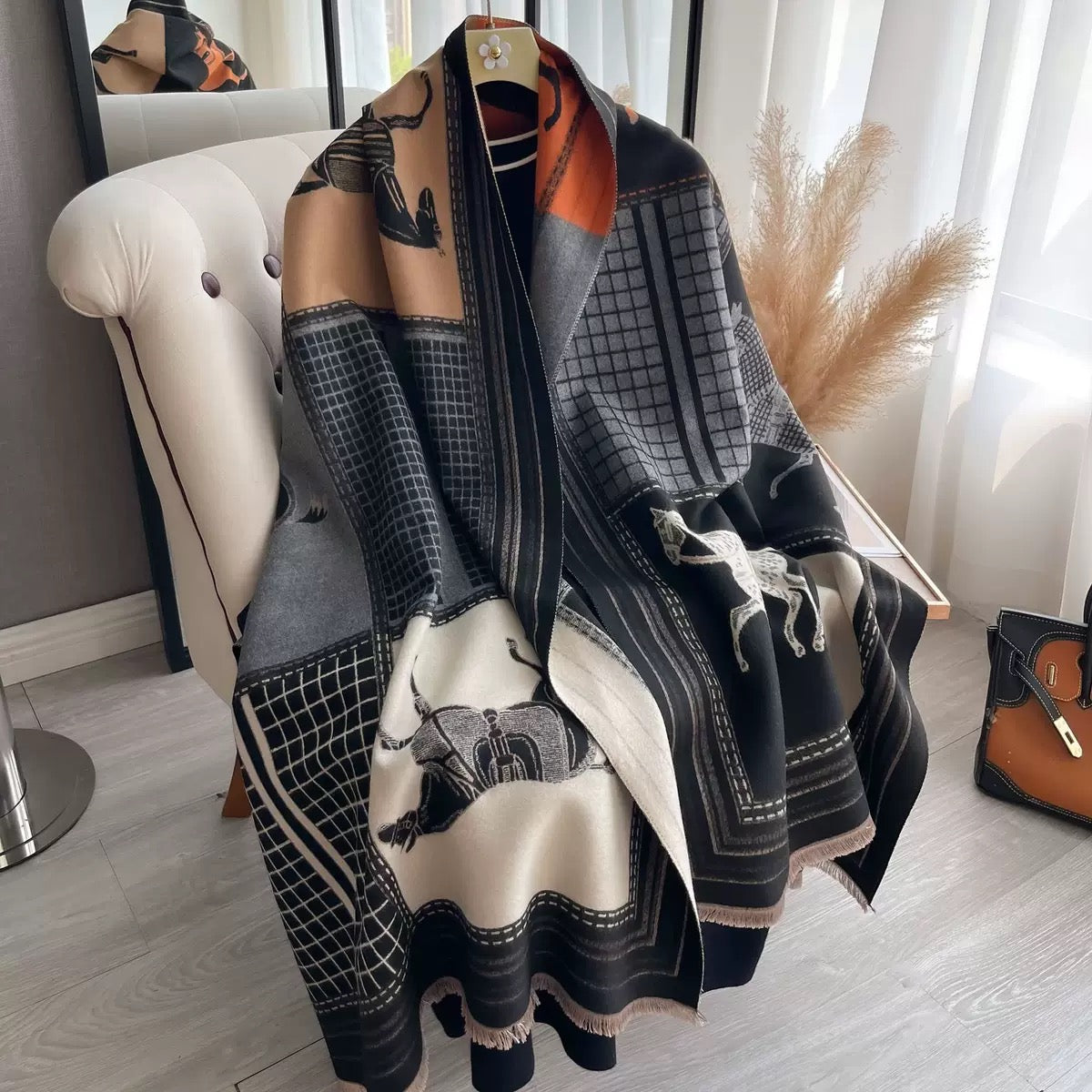 The Noir Equestrian Cashmere Wrap showing full heritage equestrian print with horse and rider motifs on deep noir black faux cashmere fabric
