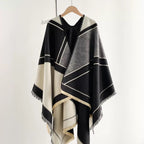 The Noir Geometry Cashmere Cape showing full black faux cashmere cape with bold geometric contrasting print in 150x130cm cape format
