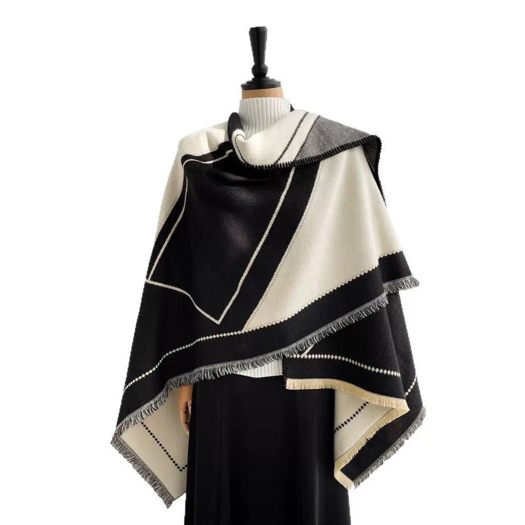The Noir Geometry Cashmere Cape worn open-front showing full geometric pattern on black faux cashmere in structured cape silhouette
