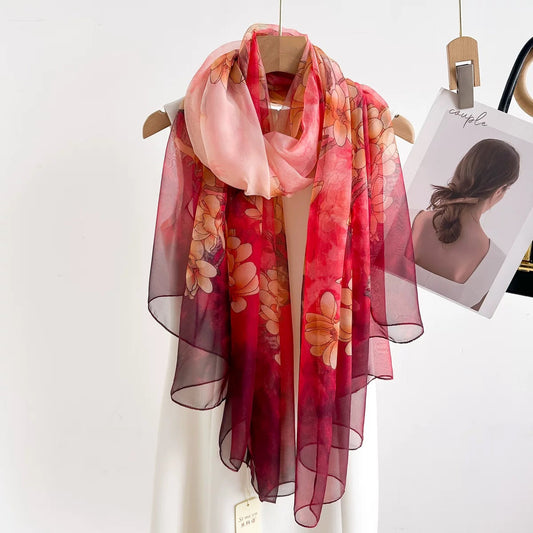 Ombre gradient organza silk scarf draped on mannequin - pink to burgundy magnolia floral scarf