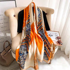 Orange beige equestrian print silk scarf draped on chair - horse motif luxury scarf with chain border