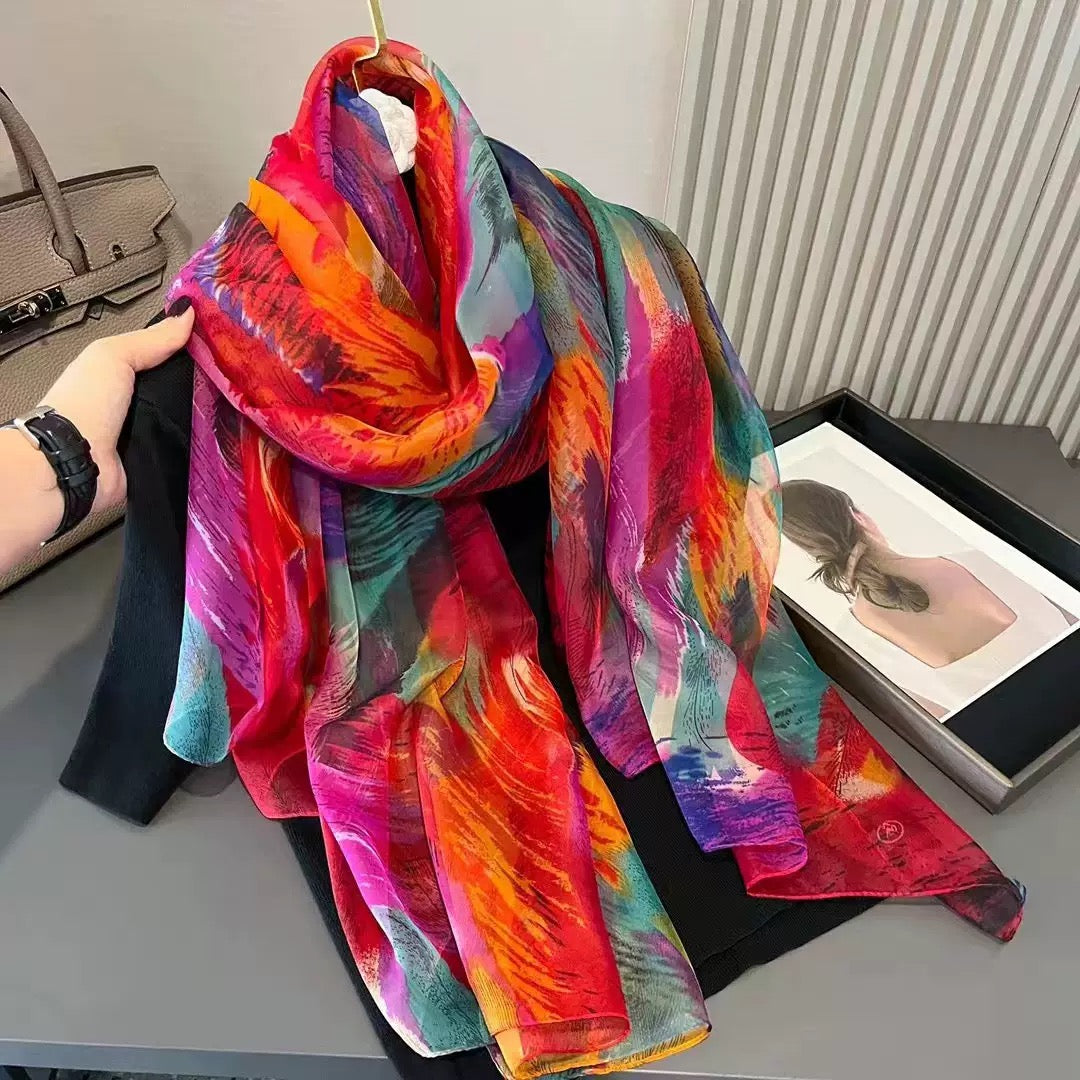 Close-up of rainbow feather print imitation silk stole showing vibrant colors and abstract pattern