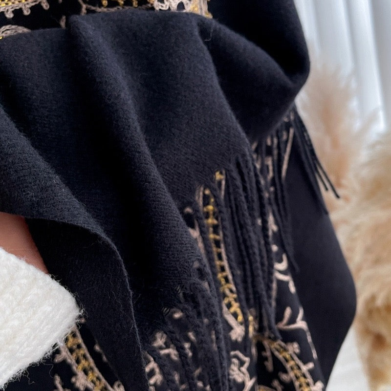 Close-up of Regal Noir Embroidered Winter Stole showing soft imitation cashmere fabric texture with gold thread embroidery and fringe tassel detail
