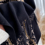 Close-up of Regal Noir Embroidered Winter Stole showing soft imitation cashmere fabric texture with gold thread embroidery and fringe tassel detail
