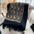 Regal Noir Embroidered Winter Stole laid flat showing full gold and beige paisley floral embroidery pattern with fringe edge on black fabric
