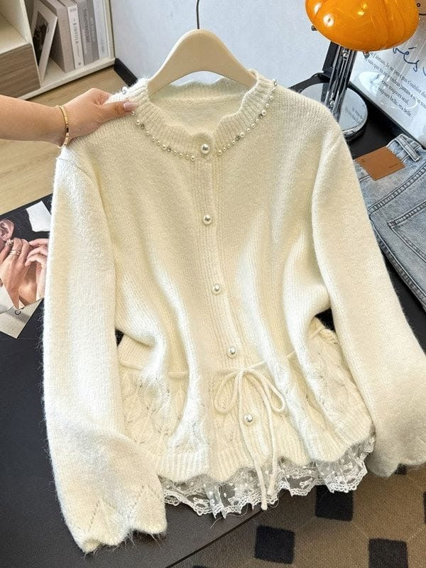 Ivory knit cardigan with pearl neckline detailing, front buttons, waist tie and decorative lace hem