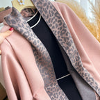 Close-up of Rosewood Leopard Trim Wrap leopard print border against blush pink faux cashmere fabric