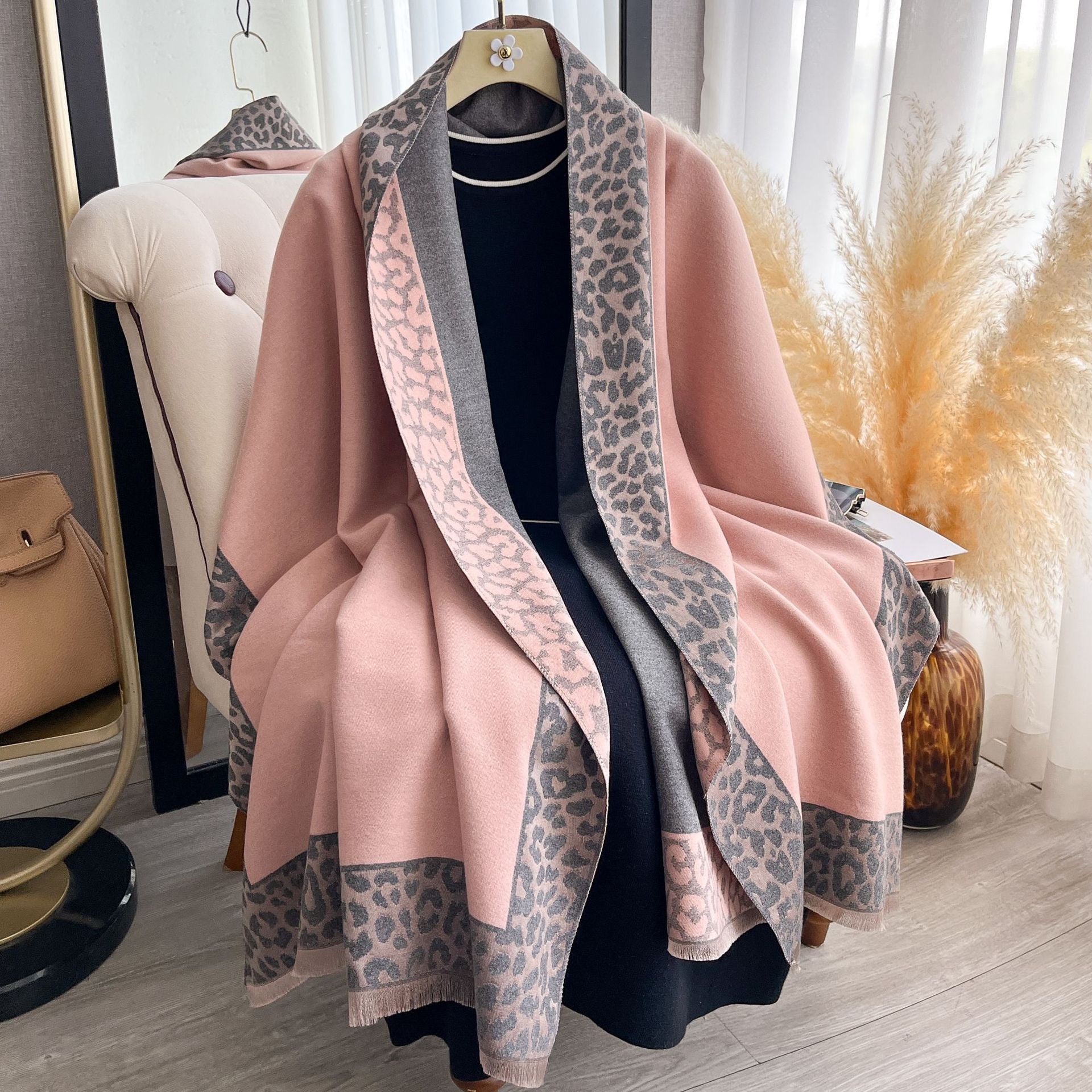 Rosewood Leopard Trim Wrap draped as a cape showing blush pink fabric with grey leopard print border