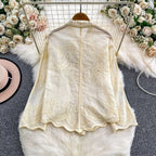Back view of Seraphine Cutwork Cotton Shirt in ivory showing embroidered yoke and scalloped hem detail