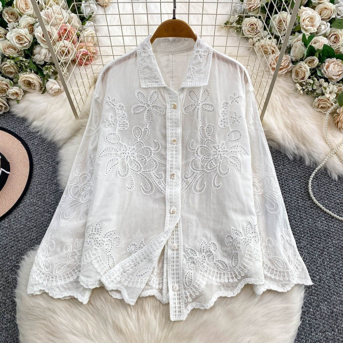 Seraphine Cutwork Cotton Shirt in ivory displayed on hanger showing  cutwork embroidery and lace placket