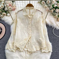 Seraphine Cutwork Cotton Shirt in ivory displayed on hanger showing full cutwork embroidery and lace placket